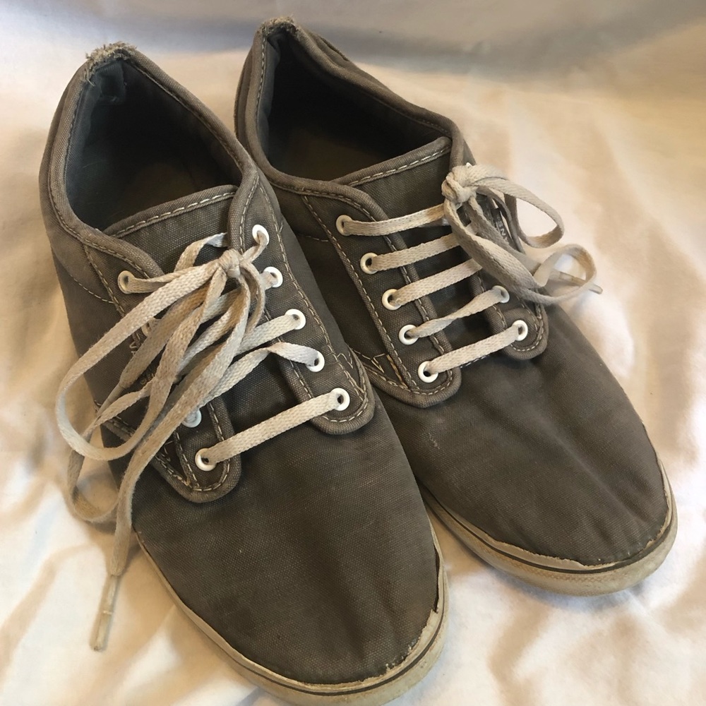 Woman’s gray vans tennis shoes